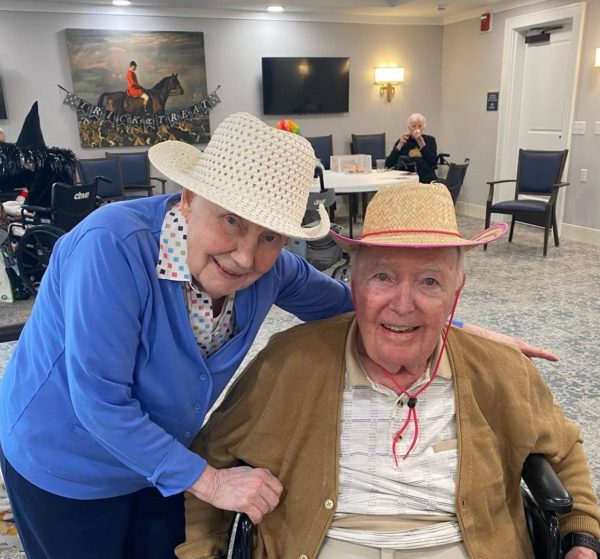 Senior couple using hats for costume